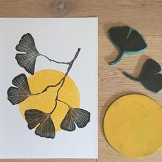 a card with some leaves on it next to two rubber stamps