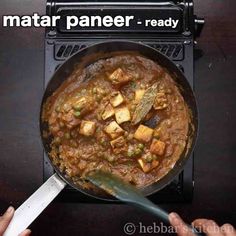 a pan filled with food sitting on top of a stove next to a spatula