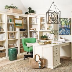 a home office with white bookcases and green chair in the corner, surrounded by wicker baskets