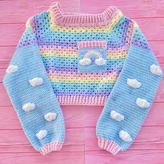 Please note that we have currently reached our capacity for jumper orders so there is a wait of 1 month for these to be made and dispatched, please keep this in mind if you are planning to order other items at the same time as they will all be dispatched together. Ultra pastel and ultra cute, our Cropped “Ultra Pastel” Rainbow Cloud Jumper / Sweater is perfect for anyone whose wardrobe is packed full of the prettiest colours ☺️Crocheted from premium quality, hardwearing and vegan friendly acrylic yarn in a beautiful pastel spectrum of colours.The sweater features a granny stitch pastel rainbow striped main with an adorable Duck Egg Blue square chest pocket that features a pastel rainbow motif with White clouds on the ends. The jumper features long sleeves that are Duck Egg Blue with White Cloud Jumper, Kawaii Crochet, Rainbow Cloud, Fun Crochet Projects, Free Crochet Patterns, Really Cute Outfits, Kawaii Clothes, Pastel Rainbow, Character Outfits