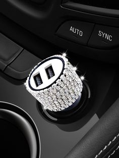 the center console button on a car with lots of diamonds and black leather trims