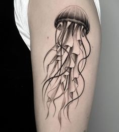 a black and white tattoo of a jellyfish