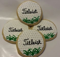 four decorated cookies with the words titleist, titleist and titleist on them