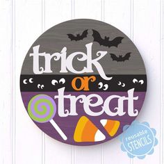 trick or treat sign with candy and bats on the front, hanging from a white wall