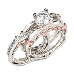 three wedding rings with diamonds on top and one diamond in the middle, set against a white background