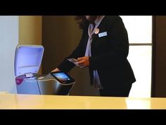 a woman standing in front of a counter with a cell phone and an electronic device