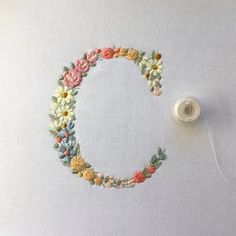 a needle is hooked up to a piece of fabric that has been embroidered onto it