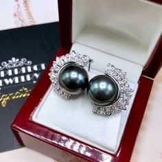 We are presenting you a HUGE pair of STUDS, Genuine, BLACK, Tahiti, South Sea Pearls, extremely FINE AA+, LUSTROUS and Rare! Accenting the 2 pearls are 54 pieces of E/VS Natural diamonds, weighting a total of 1.50 carats. Set in fabulously designed 18K solid white gold earrings. ONLY ONE ITEM AVAILABLE!! NO DUPLICATES!! WHAT YOU SEE IN THE PICTURES IS WHAT YOU WILL GET SOLIDLY HANDCRAFTED EARRINGS! SUGGESTED RETAIL VALUE: $10,880 PEARLS: Size: 15 mm Shape: Near Round Color: Grey/Black with a hin Formal Black Tahitian Pearl Earrings, Luxury Black Tahitian Pearl Earrings, Golden South Sea Pearls, Vs Diamond, White Gold Earrings, South Sea Pearls, Sea Pearls, White Gold Engagement Rings, Handcrafted Earrings