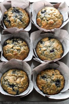 twelve blueberry muffins in paper wrappers