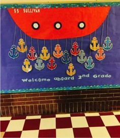 a welcome aboard and grade sign in front of a checkerboard floor with an anchor theme