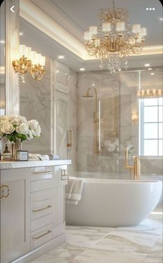 a bathroom with a tub, sink and chandelier in the middle of it