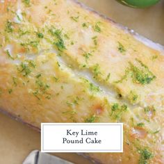 a loaf of pound cake sitting on top of a cutting board next to a knife