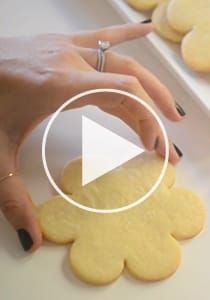 a woman is making cookies with her fingers