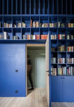 an open door leading to a room with bookshelves and shelves full of books