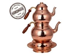 a copper colored coffee pot with wooden handles