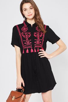 Be a wildflower in a field of roses in this bohemian beauty. This fun & flirty dress features a classic collar, button down front, short sleeves, beautiful embroidery and tassel detailing, is lined from the waist down, light weight and has an a-line mini silhouette. Small Bust 36" Length 33" Medium Bust 38" Length 33" Large Bust 40" Length 33" 65% Cotton 35% Polyester Imported Hand Wash Cold Model is 5'8" and wearing size Small Be A Wildflower, Field Of Roses, Bohemian Beauty, Down Light, Flirty Dresses, Mini Dress Black, Smocked Dress, Kimono Jacket, Beautiful Embroidery