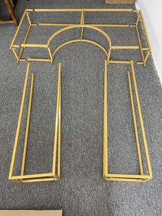 a gold metal frame sitting on top of a carpeted floor