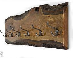 a wooden plaque with hooks attached to it