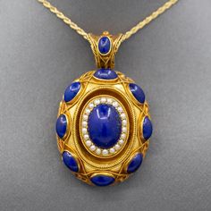 Exquisite Antique Etruscan Revival Lapis and Pearl Locket Pendant in 18k Yellow Gold The contrast in color of this locket is exquisite, and it is impeccably made.  The locket features cabochons of natural lapis lazuli, with the center cab surrounded in a frame of seed pearls.  This is a picture locket with a window on the back which can be opened and a photo inserted.  It features a really wide bail so that the piece can be worn over large chains or silk ribbon.  The locket is crafted in 18k (x Traditional Formal Jewelry With Historical Design, Yellow Gold Jewelry With Historical Design For Formal Events, Formal Yellow Gold Jewelry With Historical Design, Formal Historical Design Pendant Jewelry, Elegant Cabochon Jewelry For Ceremonial Occasions, Luxury Ceremonial Jewelry With Historical Design, Luxury Oval Necklace For Ceremonial Occasions, Traditional Oval Jewelry With Historical Design, Traditional Cabochon Necklace For Formal Occasions