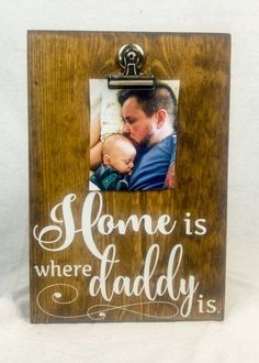 a wooden frame with the words home is where daddy is