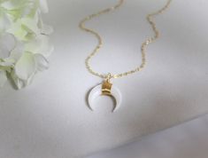 "NATURAL CRESCENT MOON NECKLACE * BOHO CHIC SMALL TUSK NECKLACE This small tusk necklace is made of Mother of Pearl. It's simple and elegant. It's light and easy to wear. Perfect for layering or wearing on its own. IT'S IN THE DETAILS * This listing is for the genuine mother of pearl necklace * 14K Gold Filled Chain - Shown at 17\" in photo #2 * Mother of Pearl Tusk in Cream or White - 20mm * To add the chain choker in photo #1, click here: https://www.etsy.com/listing/787283259 WHY YOU'LL LOVE Dainty White Crescent Necklace, White Crescent Handmade Necklace, Handmade White Crescent Necklace, Gold Crescent Moon Necklace, Tusk Necklace, Crescent Moon Necklace Gold, Gold Crescent Moon, Celestial Gifts, Horn Necklace