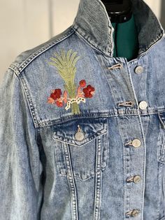 Hand Embroidered Denim Jacket Floral Bouquet | Gap X-Small Jean Jacket Hand Embroidered Denim Jacket. This denim jacket has been upcycled and lovingly hand embroidered with a floral bouquet design. DMC embroidery floss was used to create this design above the front pocket of the jacket. The embroidery measures 5" tall by 4" wide. The denim jacket has been pre-washed and air dried, with all measurements taken after drying. It is recommended to hand wash or wash on a delicate cycle to protect the Hand Embroidered Denim, Dmc Embroidery, Embroidered Denim Jacket, Dmc Embroidery Floss, Bouquet Design, Embroidered Denim, Embroidery Floss, Floral Bouquets, Front Pocket