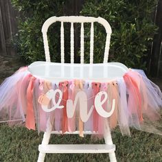 a chair with some pink and orange tulle on it