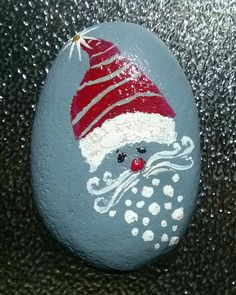 a painted rock with a santa hat on it