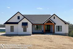 a white house sitting on top of a dirt field