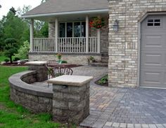 a brick house with an outdoor patio and seating area