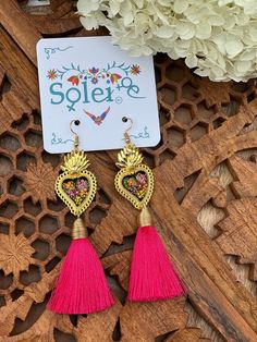 Infuse your style with a dash of Mexican charm with our hand-painted heart earrings. Each pair is meticulously crafted by skilled artisans, capturing the essence of Mexico's rich culture and artistic heritage.  Every piece is completely unique because of the detailed process that goes into creating it. The black lacquer is created by mixing in layers of dirt with a grease from the Cochinilla bug. The flowers are painted on with our finger tips using ground up natural pigments and linseed oil. To Traditional Tassel Earrings As Gift, Festival Gift Tassel Dangle Earrings, Festival Gift Jewelry With Tassels, Pink Bohemian Hand Painted Jewelry, Traditional Heart-shaped Jewelry For Festive Occasions, Adjustable Tassel Jewelry For Festivals, Nickel-free Jewelry For Valentine's Day Festival, Multicolor Tassel Earrings For Gifts, Festival Tassel Earrings As Gift