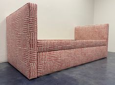 a red and white couch sitting on top of a floor next to a sign that reads sister parshadesign