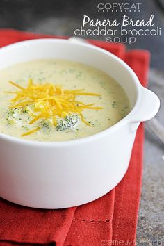 a white bowl filled with broccoli cheese soup