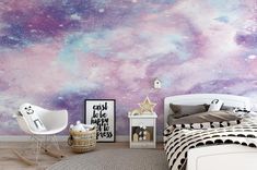 a bedroom decorated in pastel colors with stars painted on the wall