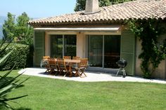 a table and chairs are outside in the grass