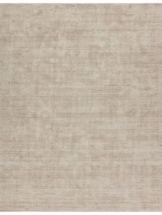 a beige area rug with no pattern on it