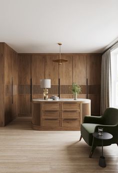 a living room filled with furniture next to a window and a kitchen counter topped with wooden cabinets