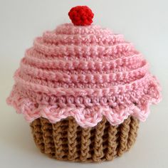 a crocheted cupcake with a cherry on top