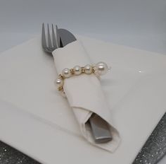 a white plate topped with a napkin and fork