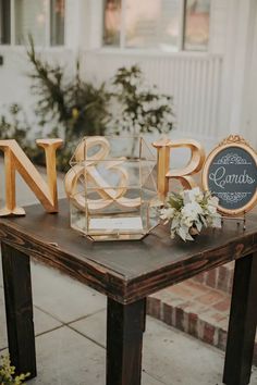 a table topped with wooden letters and flowers