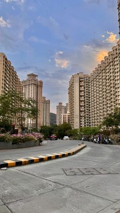 an empty parking lot with tall buildings in the background