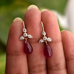 A perfect pair for your big day or the most important ladies of your tribe, these pretty earrings feature a cluster of diamond studded leaves with a Natural Ruby Drop * Diamond Wt. : 0.20 Cts * Color-Clarity Grade : H-I, VS Si * Ruby : 7 ct ( Approx) * Gold - 14K, 1.6 gms yellow gold (for other metal color, please convo) Find us on Instagram for exquisite designs: @abhikajewels Like us on Facebook: www.facebook.com/Abhikajewels Thank you for visiting our shop.. :) Drop Earrings With Single Cut Diamonds, Exquisite Gemstone Drop Diamond Earrings, Diamond Briolette Earrings For Wedding, Elegant Ruby Earrings With Diamond Accents, Diamond Teardrop Earrings Fine Jewelry, Diamond Briolette Earrings For Anniversary, Fine Jewelry Dangle Earrings With Single Cut Diamonds, Fine Jewelry Briolette Earrings For Anniversary, Pear-shaped Diamond Earrings With Gemstones