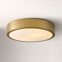 a close up of a light fixture on a ceiling with white walls in the background