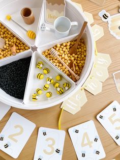 a table topped with lots of different types of cards next to cups and spoons