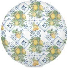 a plate with lemons on it and blue tile design in the center, against a white background