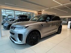 a range rover parked in a showroom with other cars