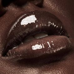 a woman's lips with white paint on them and the lip is dark brown