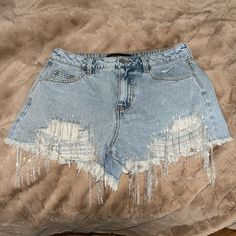 Denim Shorts With Silver Sparkly Fringe At Front Distressed Summer Party Cutoff Bottoms, Party Cutoff Denim Shorts, Casual Denim Bottoms For Party, Casual Denim Party Bottoms, Blue Denim Bottoms For Party, Short Denim Jeans For Party, Mid-rise Denim Bottoms For Party, Denim Party Shorts, Blue Denim Party Bottoms