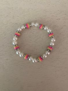 this bracelet is perfect for summer! it is a pearl based bracelet with sunset inspired clay beads all around! White Pearl Bracelet With Colorful Beads For Beach, Clay Bead Bracelet Pearl, Cute Pink Pearl Bracelet With Round Beads, Pink Pearl Bracelet With Colorful Beads For Beach, Light Pink Clay Bead Bracelet, Bracelet Inspo, Pink Sunset, Clay Bead, Clay Beads