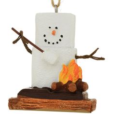 a snowman made out of toilet paper sitting on top of a log with a fire in it